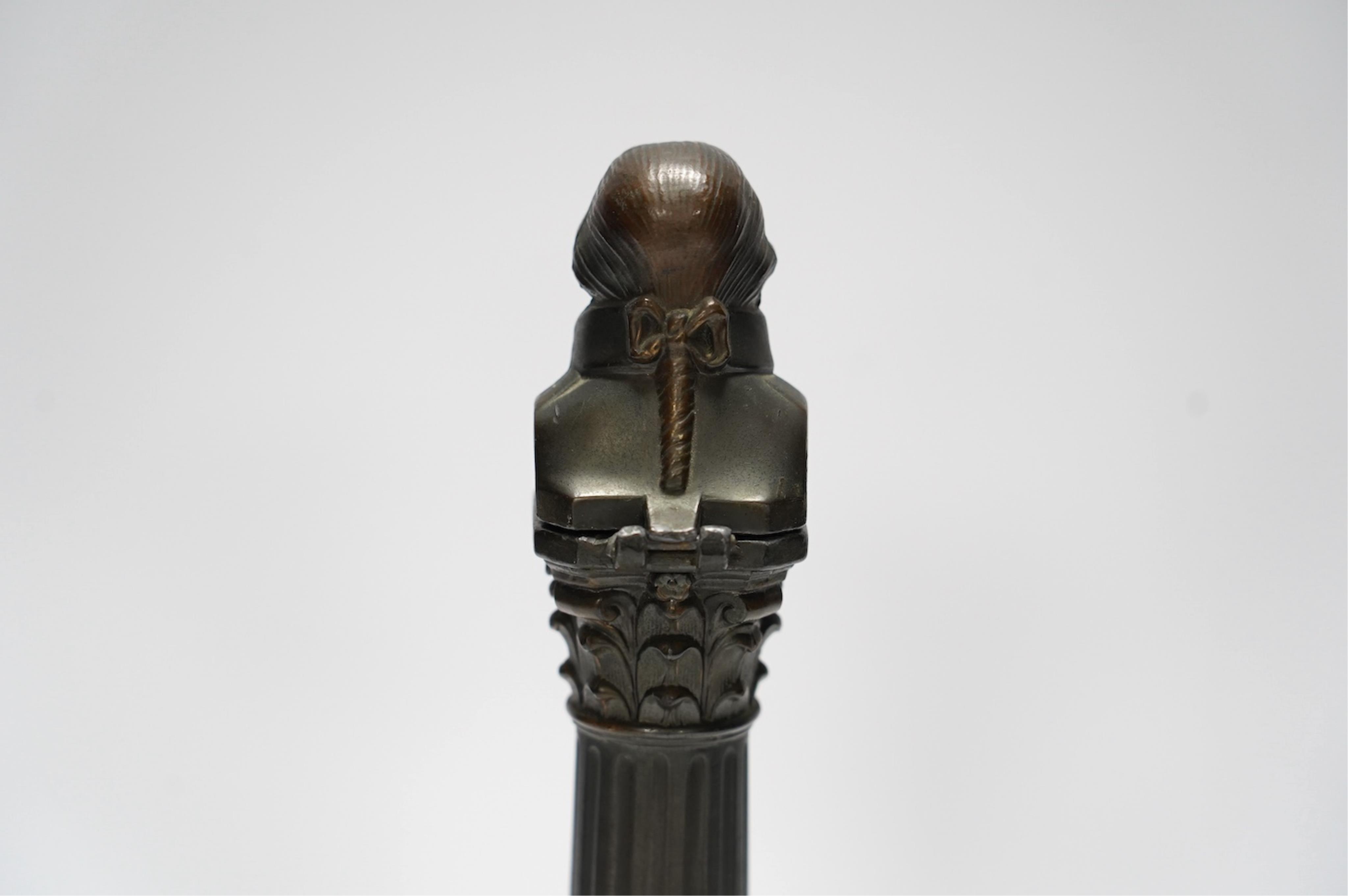 A spelter bust of Lord Nelson on a column table lighter, 25cm high. Condition - poor to fair, hinge broken, untested